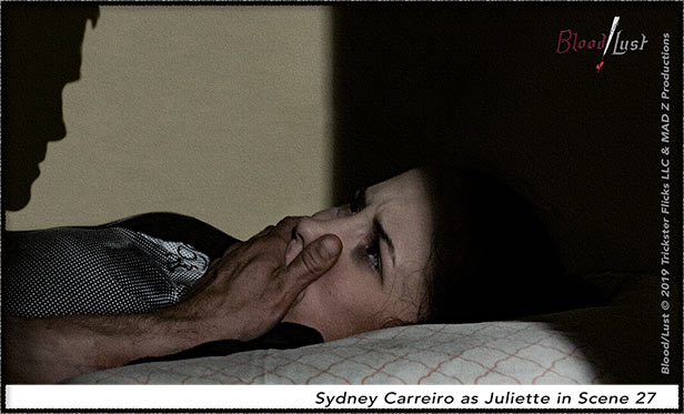 Juliette in bed with a hand on her month.